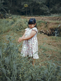 Cute girl standing on field