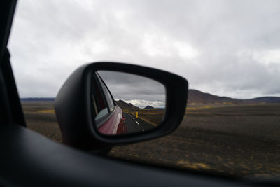 Reflection of sky on side-view mirror