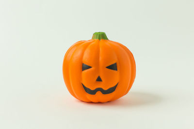 Close-up of pumpkin against orange background