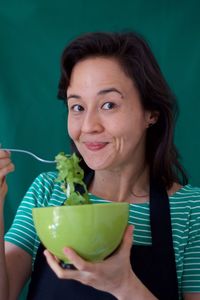 Portrait of a smiling young woman holding ice cream