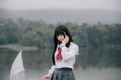 Portrait of smiling young woman standing outdoors