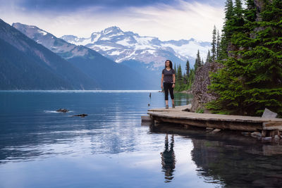 Man on boat in mountains against sky