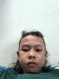 Portrait of girl against wall