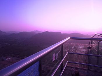 High angle view of railing against mountain during sunset