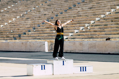 Full length of woman walking on staircase