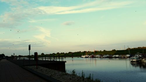 Scenic view of river against sky at sunset