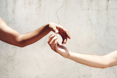 Cropped image of couple against wall