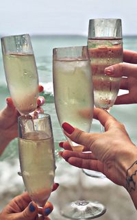Cropped hands toasting champagne flutes 