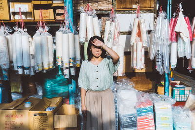 Portrait of a smiling young woman standing in store