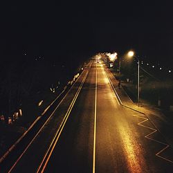 View of illuminated street lights at night