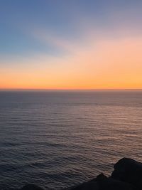 Scenic view of sea against clear sky during sunset