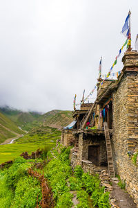 Historic building by mountain against sky