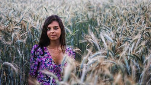 Portrait of woman standing in field