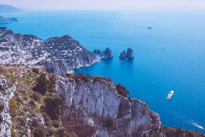 High angle view of rocks by sea against sky