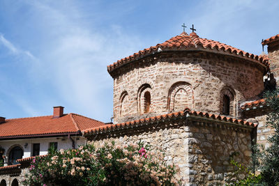 Low angle view of very old church building against sky