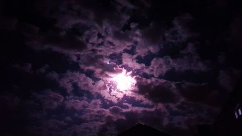 Low angle view of silhouette purple sky at night