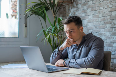 Young man using laptop at office