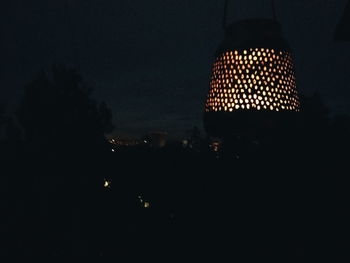 Low angle view of illuminated lamp at night