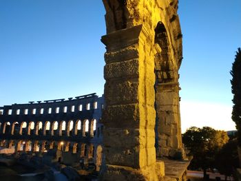 Low angle view of historical building against clear blue sky