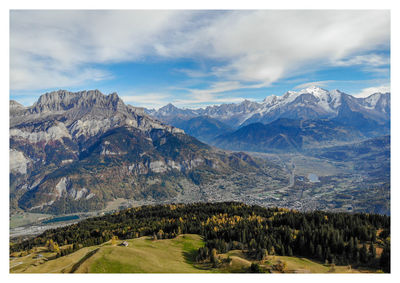 Scenic view of mountains against cloudy sky