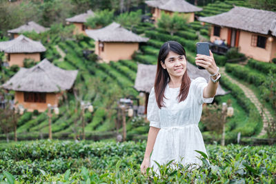 Portrait of woman photographing with camera