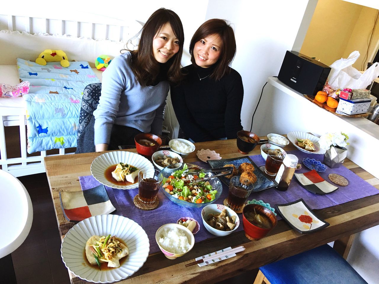 two people, table, togetherness, young adult, sitting, indoors, happiness, adult, men, home interior, food, lifestyles, adults only, friendship, domestic life, people, young women, women, real people, technology, domestic room, birthday cake, day