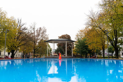 Man swimming in pool against clear sky