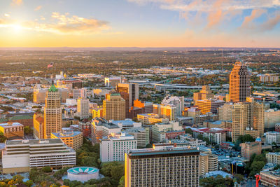 Aerial view of cityscape against sky during sunset