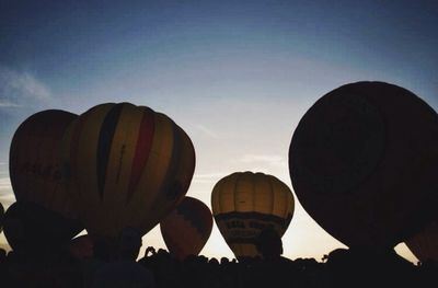 Low angle view of people against blue sky