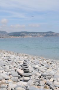 Stones on beach against sky