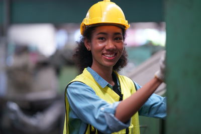 Portrait of young man standing in factory