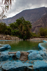 Scenic view of lake against cloudy sky