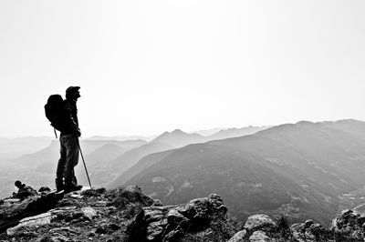 Man standing on mountain against sky