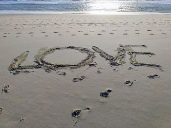 High angle view of text on beach