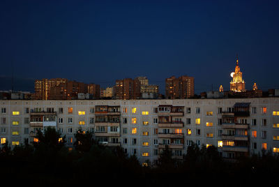 Night view of the round house in moscow, with moon and moscow state univercity at the background