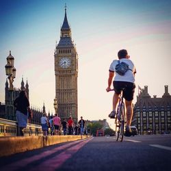 People at westminster bridge by big ben in city