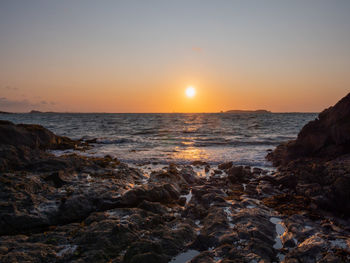 Scenic view of sea against sky during sunset