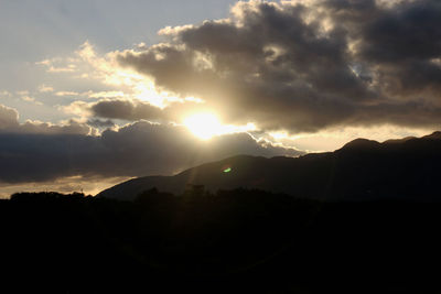 Silhouette landscape against scenic sky