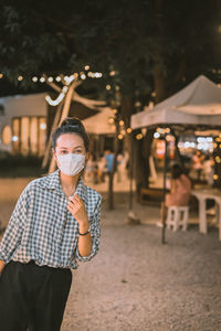 Series photo of young woman tourist wear surgical medical mask touring in street night market