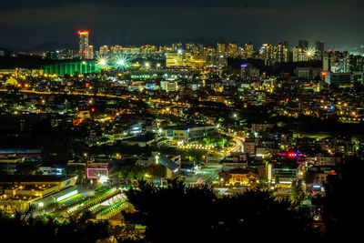 Aerial view of city lit up at night