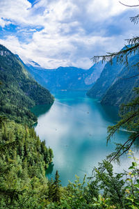Scenic view of lake by mountains against sky