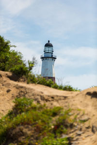 Scenic view of lighthouse against cloudy sky