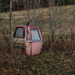 Abandoned car on field