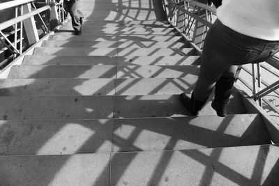 Low section of people walking on tiled floor