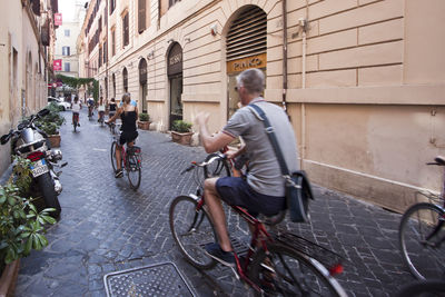 Man riding bicycle on street in city
