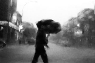 Side view of man running on street in city