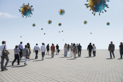 Group of people flying against clear sky