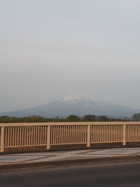 Road by mountains against clear sky