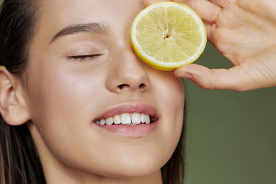 Close-up of woman holding lemon