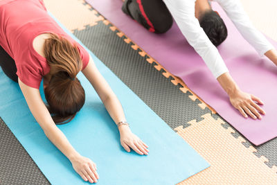 High angle view of people doing yoga at studio